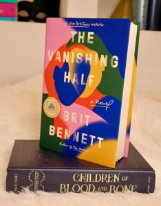 Brit Bennett's book, The Vanishing Half, standing on top of the Children of Blood and Bone book. 